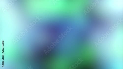 Abstract organic shapes bloom with soft light during a gentle flowing motion revealing vibrant blue and green hues