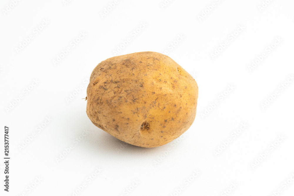 Fototapeta premium Single fresh raw brown baby potato isolated on a white background