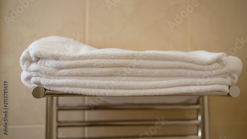 Konstfotografi Stacked white towels on chrome rack in bathroom