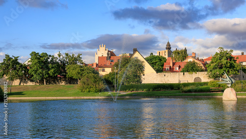 Serene summer twilight over Almedalen park and historic Visby wall