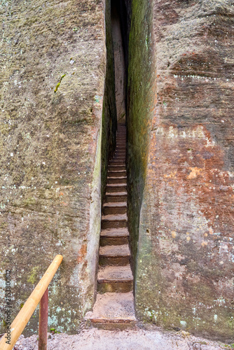 Photography Narrow stone staircase between tall rock formations in natural canyon passage