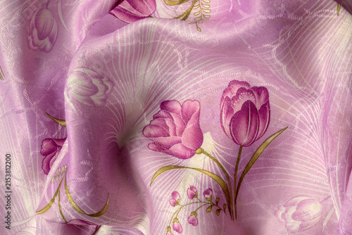 pink silk material with a fold around a large tulip and small flowers