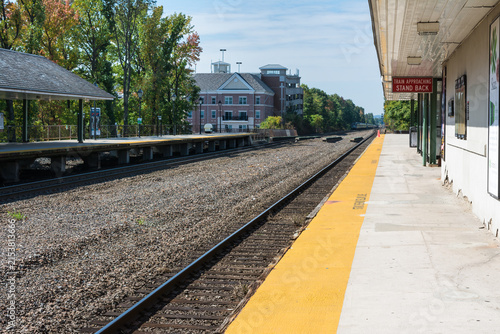 Long, perspective view of a train station in New Jersey showing the tracks and platform