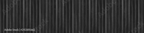 Vertical black wooden slats arranged in a seamless wide panoramic panel pattern.