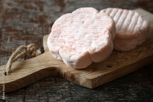 French Saint Albray cheese on white wooden cutting board