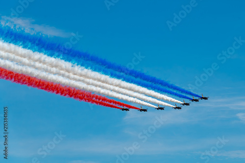 Obraz na plátne Jets fly formation leaves parallel tricolor smoke trails