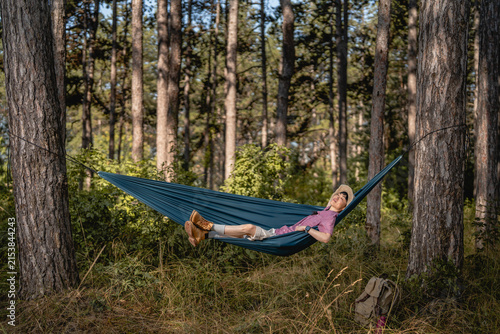 Fotografie Woman relaxing in hammock enjoying nature in forest