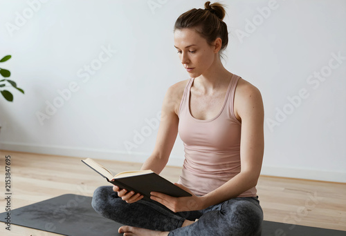 Young woman reading a book ...