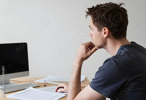 Thoughtful young man workin...