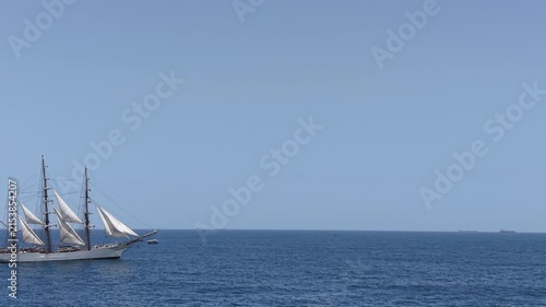 Aerial view of a three-masted sailing ship with sails sailing in the Atlantic Ocean. 