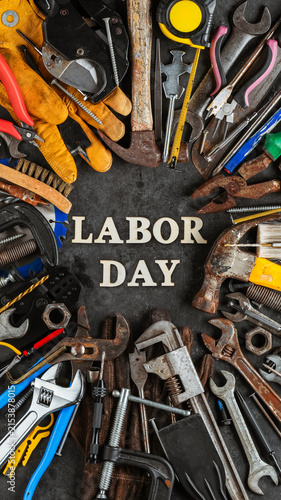 Group of used and worn work tools with Labor day text. Symbolic of the labor movement and pride working class or blue collar workers. Celebrate Labor Day or International Workers Day.