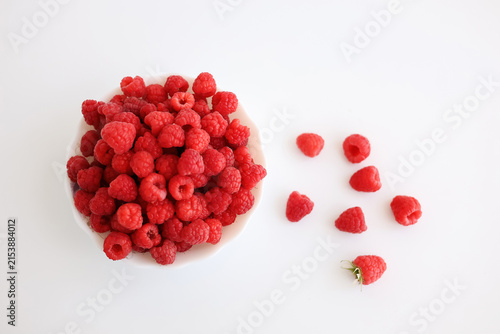 Obraz na płótnie A close‑up of a red raspberry on a white background.