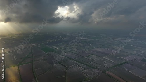 Panoramic aerial view of black storm clouds above flooded plains after heavy rain.