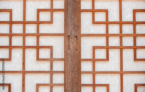 Close up of traditional Korean hanji sliding doors with geometric wooden latticework in South Korea.