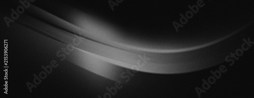 The black background with fine folds in the image creates the illusion of fabric falling or blowing dynamically in the wind.	