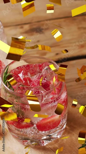 Animation of confetti falling over glasses of water with strawberries
