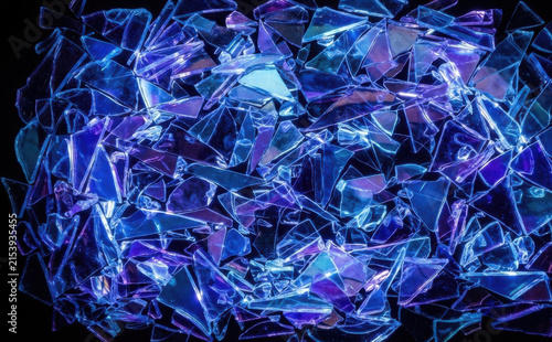 Abstract background of glowing blue and purple broken glass shards and fragments creating a futuristic cybernetic texture and design