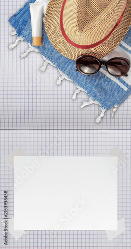 Summer Wallpaper with Straw Hat, Towel, Sunglasses, Protection Cream and White Blank Free Space Paper Sheet with Adhesive Tape on School Notebook with Millimeter Grid Pages. File with Clipping Path.