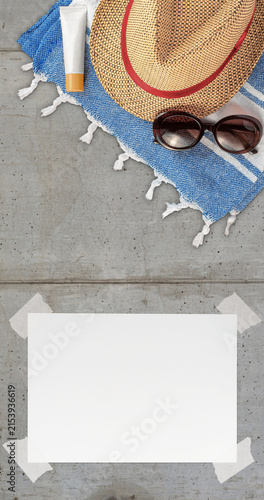Summer Wallpaper with Straw Hat, Towel, Sunglasses, Protection Cream and White Blank Free Space Paper Sheet with Adhesive Tape on Concrete Textured Surface. File with Clipping Path.