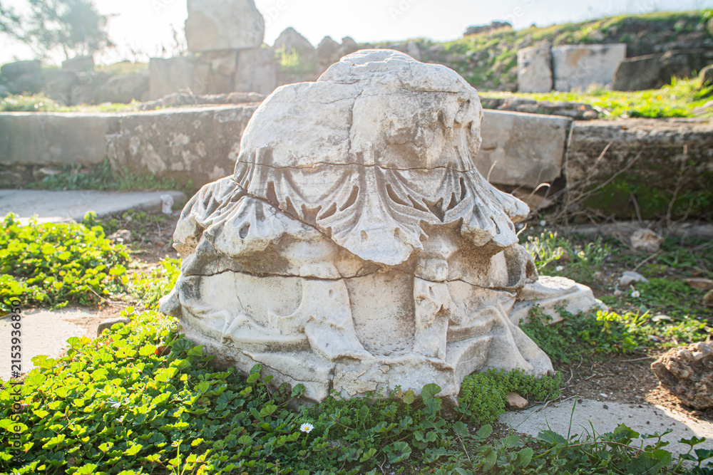 Fototapeta premium Ornate ancient Roman marble column capital with floral carved relief archaeological site in Turkey