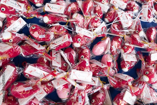 Obraz na płótnie High angle view of Japanese lucky red tai fish fortune charms lined up, horizont