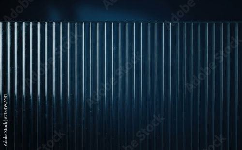 Dark blue ribbed glass texture background with vertical lines and minimal abstract industrial design pattern for modern architectural concepts and futuristic tech wallpapers