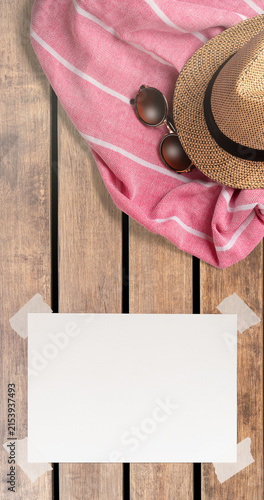 Summer Holiday Vacation Trip Mockup Concept Wallpaper with White Blank Free Space Paper Sheet with Adhesive Tape on Wooden Surface. File with Clipping Path.