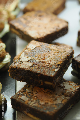 Brownies on display at a bakery in the afternoon
