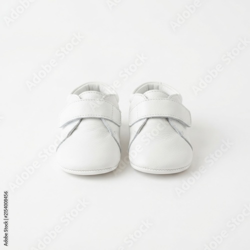 Pair of small baby shoes on white background