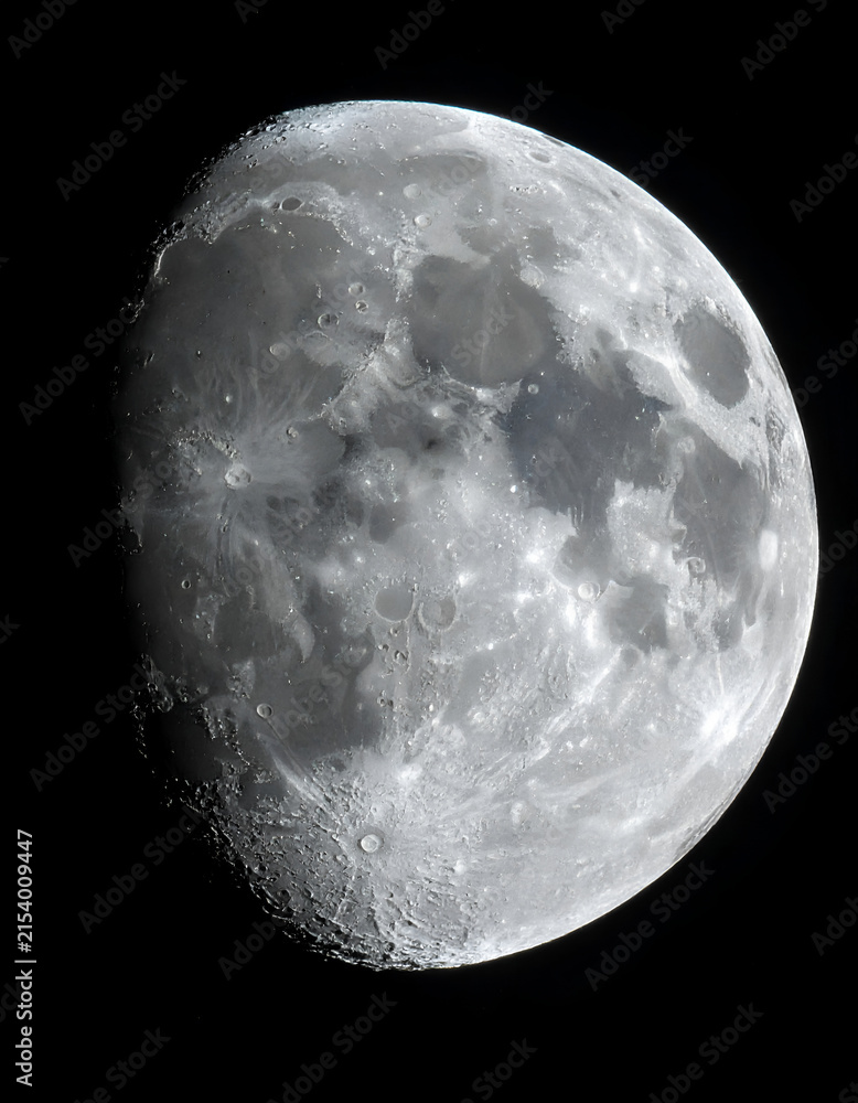Obraz premium Detailed view of the Moons surface with craters and maria against a black sky.