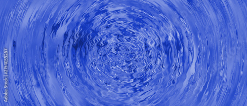 Vibrant blue water background featuring concentric ripples and circular liquid waves.