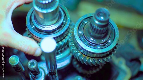 Mechanic examining intricate gears in workshop setting