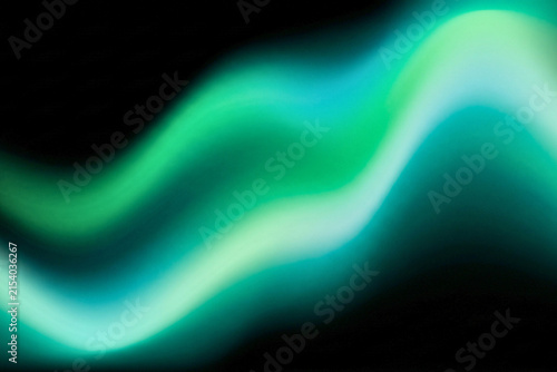 Smooth luminous wave combining green, turquoise, and cyan tones.