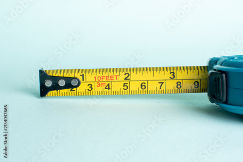 Canvas Print Yellow measuring tape extended close up representing precision measurement size