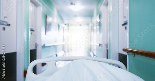 Foto Medical, trolley and patient in bed at hospital, admission and emergency for urgent surgery