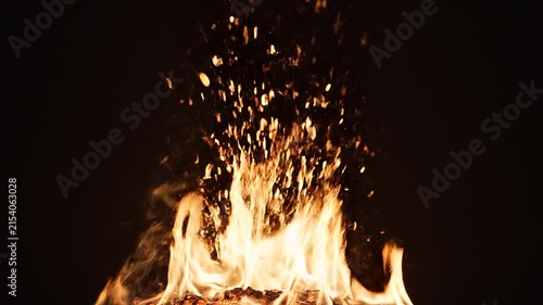 Powerful shower of hot fire sparks rapidly rising from the bottom of the frame into darkness, thousands of realistic glowing embers, natural sparks with irregular trajectories