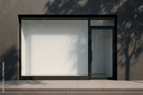 Empty black-framed store front with large display window and glass door in minimalist modern style, shadows of trees on wall and pavement visible. Ai generative
