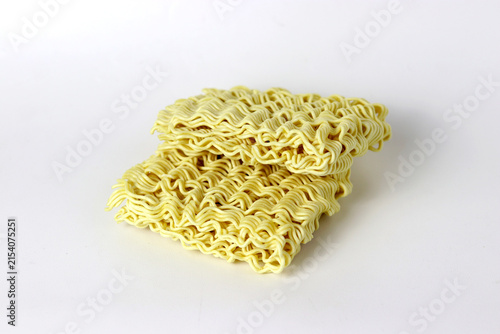 Uncooked instant noodles stacked on a clean white background