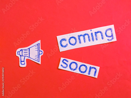 Coming soon message with hand-drawn megaphone and text on red background