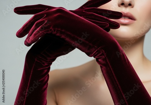 Elegant woman wearing long dark red velvet gloves for formal fashion