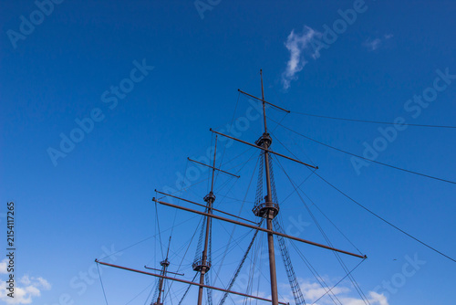 Fotografie Majestic sailing ship masts against azure sky, towering rigging of historic tall ship silhouette
