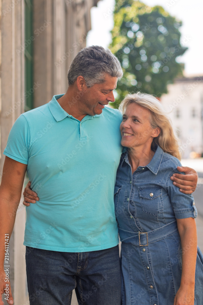 Fototapeta premium Smiling mature couple standing close together outdoors