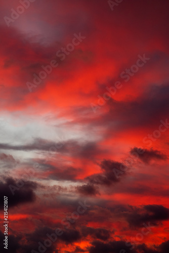 Dramatic red sunset sky with dark storm clouds