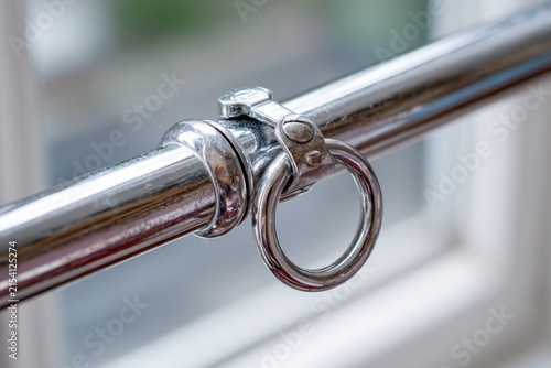 Close-up of Polished Chrome Curtain Rod with Hanging Ring Detail in Modern Home Interior, Year 2025