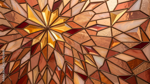 Geometric Stained Glass Pattern with Golden Starburst Center and Amber, Red, and Beige Triangular Segments