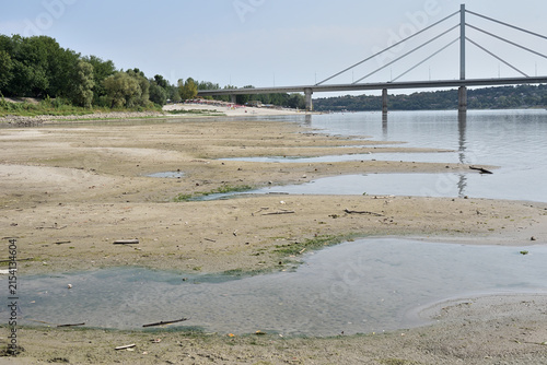 Canvas Print Low river water level on the Danube with suspended cargo ship navigation due to