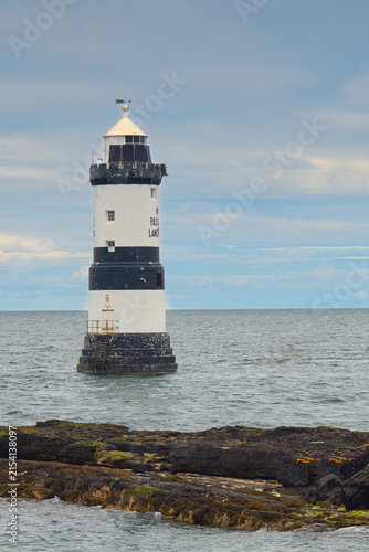 The iconic black and white striped Trwyn Du Lighthouse at Penmon Point, Isle of Anglesey, North Wales.  Trwyn Du Lighthouse is also known as Penmon Lighthouse.