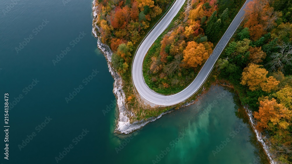 Obraz premium The Winding Road Through Autumn Forest Over Turquoise Lake Panorama