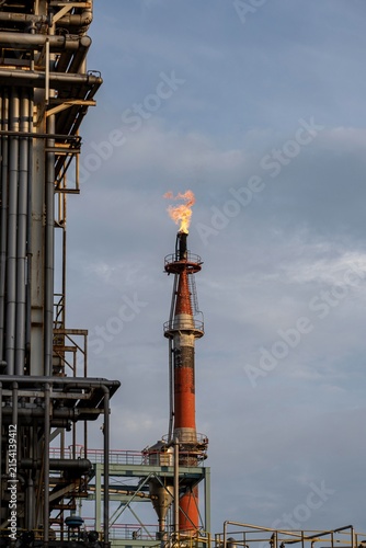 Oil Refinery Flare Stack Burning Gas at Industrial Petrochemical Facility