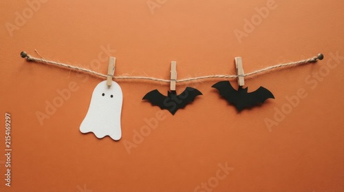 Halloween garland with ghost and bats on orange background